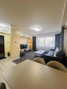 a living room with a couch and a table at Och Service Apartment in Ulaanbaatar
