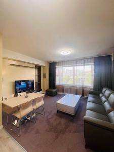 a living room with a couch and a table at Och Service Apartment in Ulaanbaatar