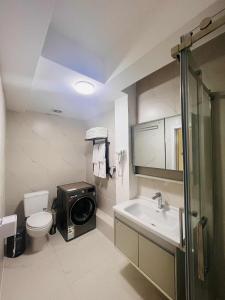 a bathroom with a sink and a washing machine at Och Service Apartment in Ulaanbaatar +54 photos