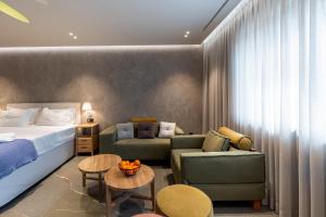 a hotel room with a bed and a couch at Selemnos Boutique in Patra