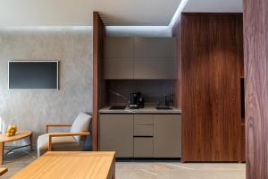a kitchen with a counter and a table at Selemnos Boutique in Patra
