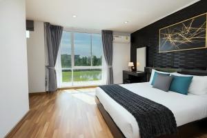 a bedroom with a large bed and a large window at Spacious 3BR BKK NEAR 3 Private Bathrooms FAMILY STAY in Min Buri