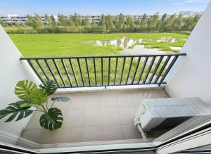 a balcony with a view of a green field at Spacious 3BR BKK NEAR 3 Private Bathrooms FAMILY STAY in Min Buri