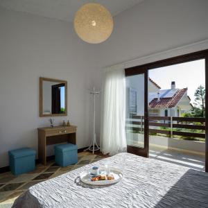 a bedroom with a bed with a plate of fruit on it at Cyan Villa in Anavyssos