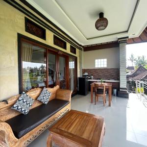 a living room with a couch and a table at Bhakti Ubud Villa in Ubud