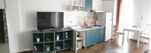 a living room with a tv and a blue cabinet at Anca's Style in Codlea