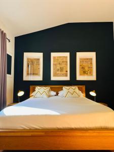 a bedroom with a large bed with three pictures on the wall at Auberge d'Anais in Vaison-la-Romaine +50 photos