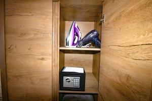 a wooden closet with a phone and shoes in it at Central garsoniera ap 3 in Târgu-Mureş