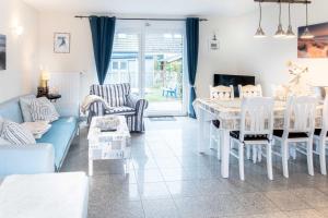 a living room with a blue couch and a table at Ferienhaus Kranich in Pruchten +39 photos