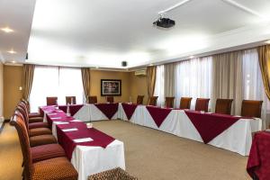 a conference room with a long table and chairs at Premier Hotel Anta Boga in Bloemfontein