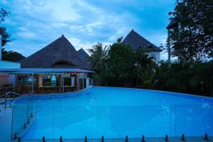 a large swimming pool in front of a resort at Seaclusion Diani in Diani Beach