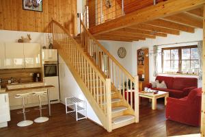 a kitchen and a living room with a staircase at Eifelhof Bock in Hürtgenwald