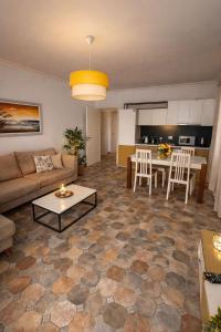 a living room with a couch and a table at Shengjin apartaments in Lezhë