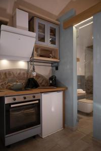 a kitchen with a stove and a sink at Yermata Kalamoti in Kalamoti +50 photos