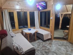 a living room with a couch and a table at Markove kolibe 5, Uvac, Sjenica in Sjenica