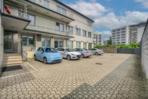 a row of cars parked in a parking lot in front of a building at Sport Rooms II Chodakowska Warszawa in Warsaw