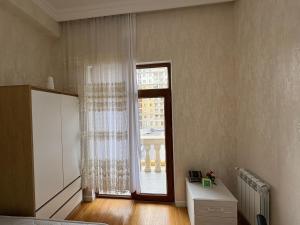 a room with a large window and a door at Caspian Residence in Sumqayıt