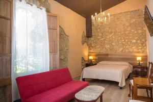a living room with a red couch and a bed at L'Otelet By Sweet in Valencia +85 photos