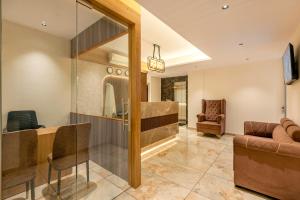 a living room with a couch and a table at Hotel Hycon in Kozhikode