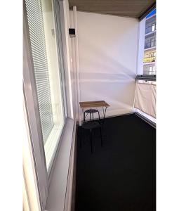 a small table in a room with a window at LuxHOMES Studio in Tapiola in Espoo