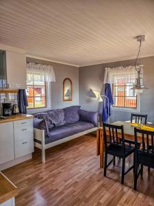 a living room with a couch and a table at Strandbacka Stugor in Gnisvärd