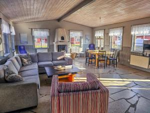 a living room with a couch and a table at Strandbacka Stugor in Gnisvärd