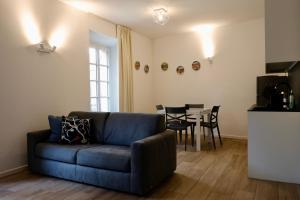 a living room with a couch and a table at Piazza del Lago Suites - Menaggio in Menaggio