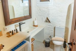 a bathroom with a sink and a toilet at Villa Art Natalie in Kithnos +82 photos