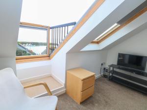 a living room with a large window and a tv at Still Waters in Wyke Regis