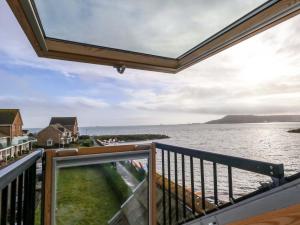 a balcony with a view of the water at Still Waters in Wyke Regis