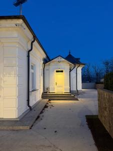 a white building with a yellow door at Ghica Boutique Suites in Vaslui
