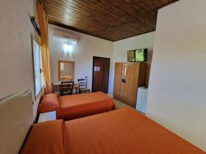 a hotel room with two beds and a kitchen at Casolare Al Porto in Tropea