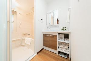 a bathroom with a sink and a shower at NISHIKI Ryokan錦旅館 in Tokyo +36 photos