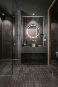 a bathroom with a sink and a mirror at Kersh Dolomites Lodge in San Candido +30 photos