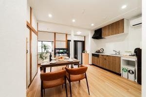 a kitchen with a table and chairs in a room at NISHIKI Ryokan錦旅館 in Tokyo