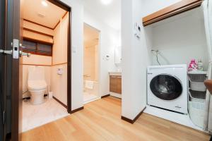 a bathroom with a washing machine and a toilet at NISHIKI Ryokan錦旅館 in Tokyo