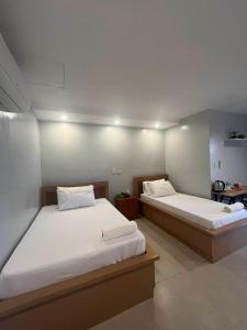 two beds in a room with two beds sidx sidx sidx sidx at ALESSANDRA HOTEL in Calaca