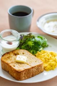a plate of breakfast food with toast and scrambled eggs at 北国ロッヂ in Otari +9 photos