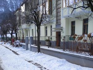 a snow covered street in front of a building at Meri per sempre in Pontebba