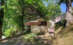 a patio with an umbrella and a table and chairs at Casa Lisandru in Croce