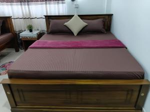 a bed in a bedroom with a wooden bed frame at katunayake city apartment in Katunayaka