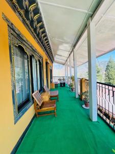 a porch with benches on a balcony at sinchula Villa Resort in Paro