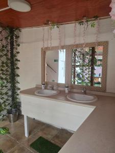 a bathroom with two sinks and a mirror at Andes Hostal Serena in La Serena +18 photos