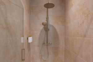 a shower with a shower head in a bathroom at L'escapade Vosgienne, Cinéma, Balnéo in Remiremont +22 photos