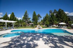 a swimming pool with a fountain in a yard at Cemayu Lodge in Oxapampa +115 photos