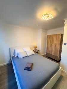 a bedroom with a large bed with a light on the ceiling at Apartment Café Ettelbrück in Ettelbruck