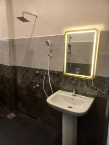 a bathroom with a sink and a mirror at Calm Stay in Badulla