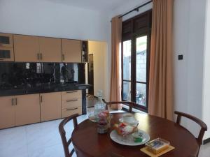 a kitchen with a wooden table with chairs and a dining room at Calm Stay in Badulla