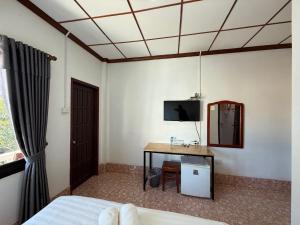 a bedroom with a bed and a desk and a tv at Phaythavone Hotel in Pakse +89 photos