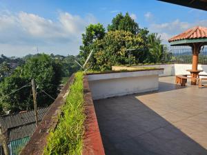 a patio with a bench and a gazebo at Queens Residence Homestay in Kandy